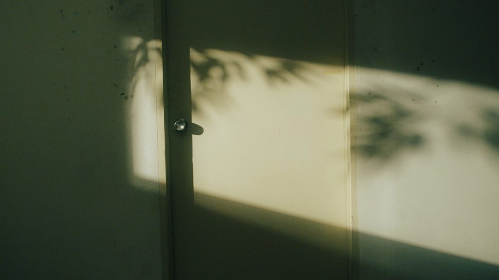 evening indoor, sun casting a beam of light on the door