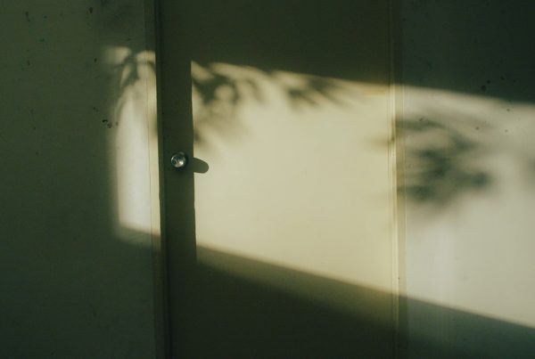 evening indoor, sun casting a beam of light on the door