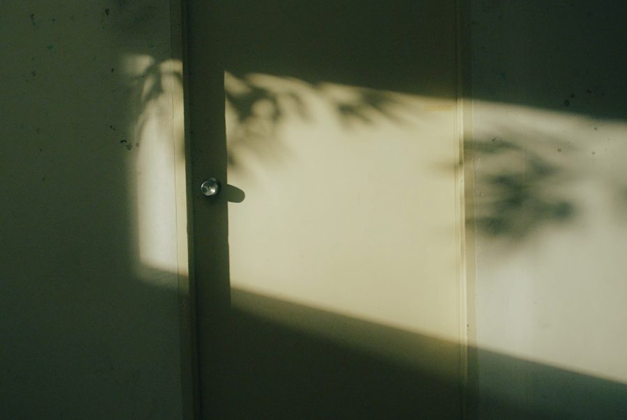 evening indoor, sun casting a beam of light on the door