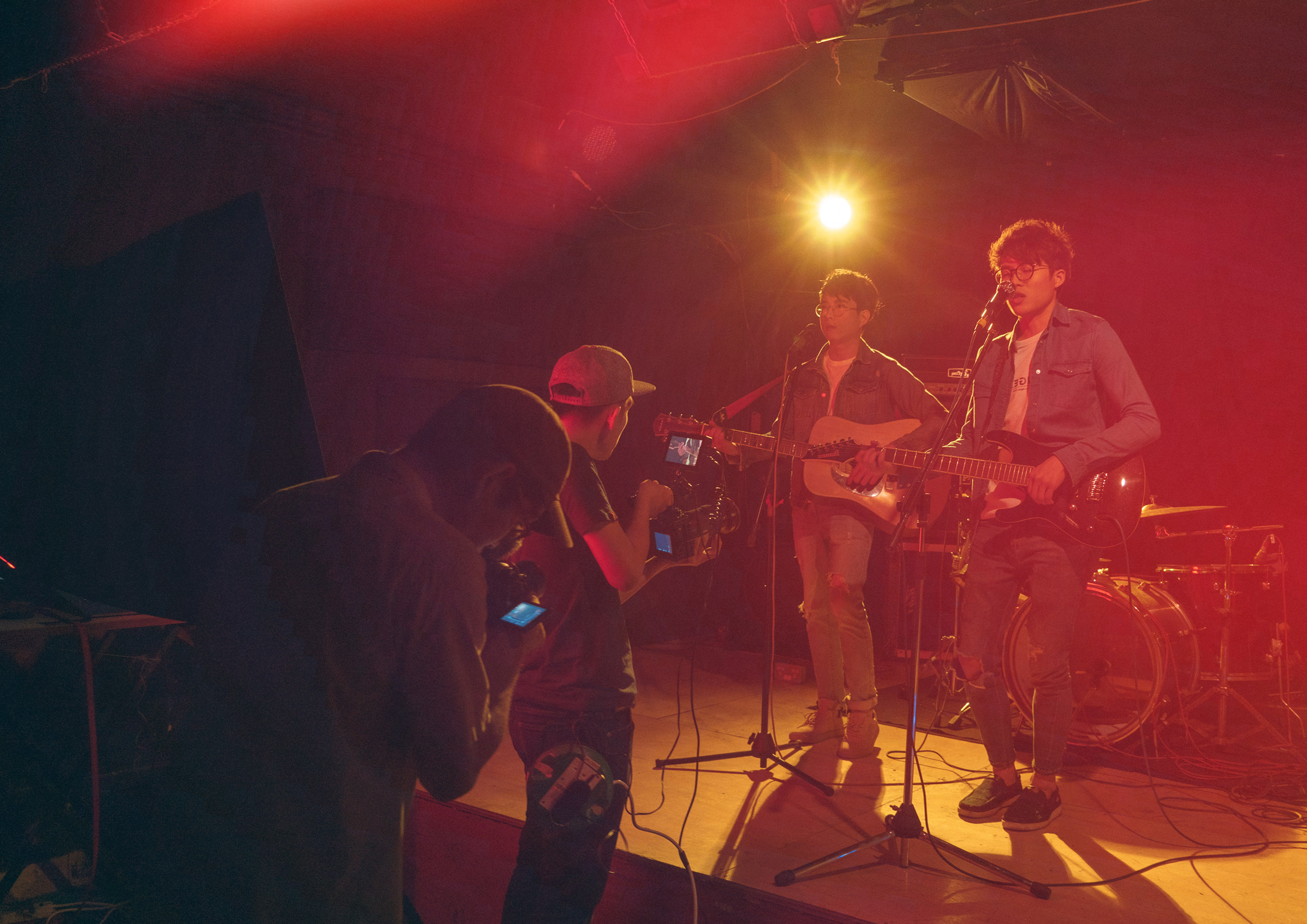 Music video shoot in a dark room with music band