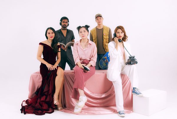 a photoshoot in white background studio with a group of talent