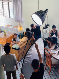 Video production team working behind the scene with lighting and camera setup